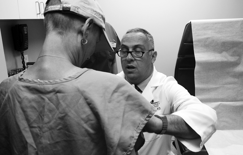 East Brunswick plastic surgeon Dr. Robert Herbstman examines Aimee during a pre-operative consultation.