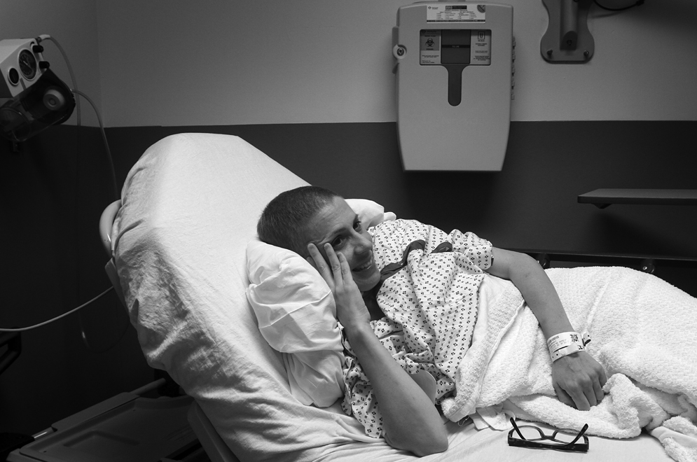 Aimee smiles while resting in a pre-op quiet room prior to double mastectomy and breast reconstruction surgery.