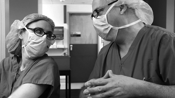 Surgical oncologist Laurie Kirstein, MD, and plastic surgeon Robert Herbstman, MD, scrub prior to performing a bi-lateral mastectomy and reconstruction on Aimee.