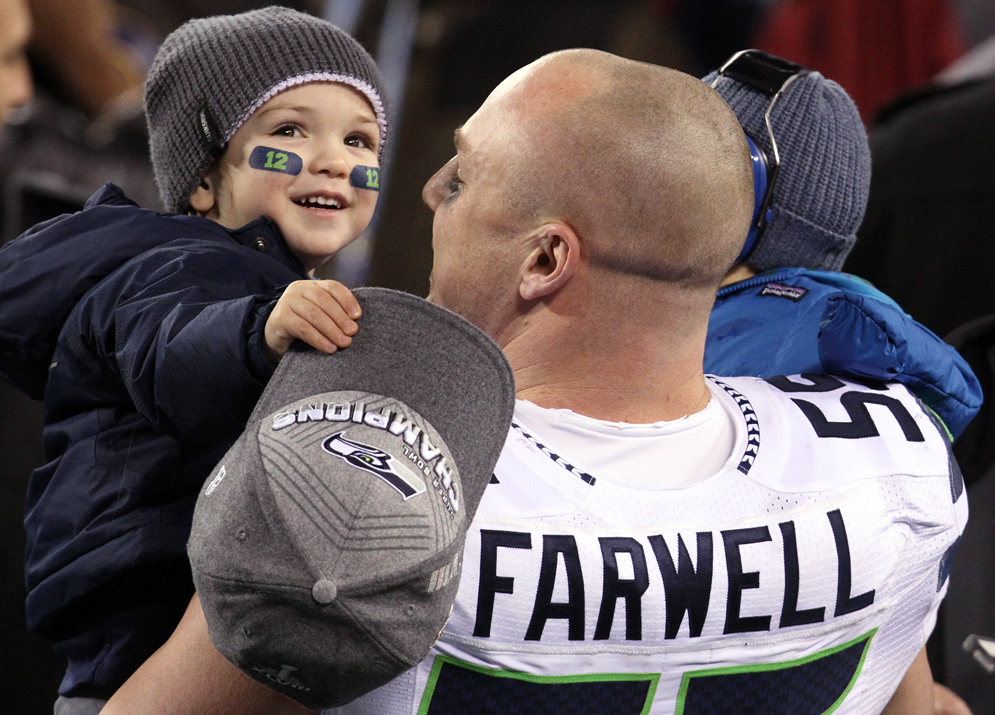 Seattle's Heath Farwell holds his children during the Super Bowl XLVIII celebration, Sunday, February 2, 2014, at MetLife Stadium in East Rutherford, NJ.